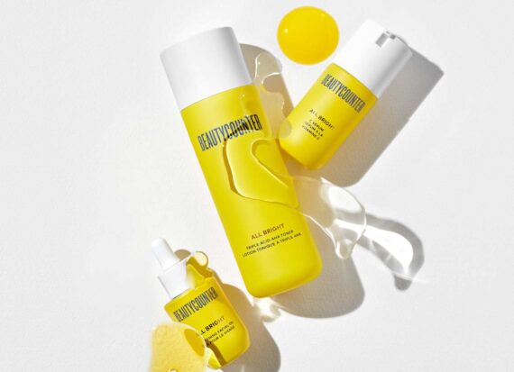 Yellow bottles with white tops for face care products and serums