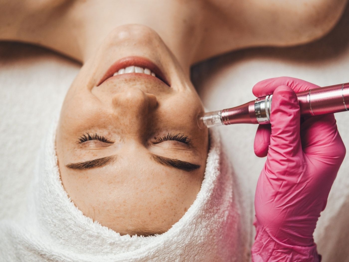 Woman at a spa getting microdermabrasion done with a device
