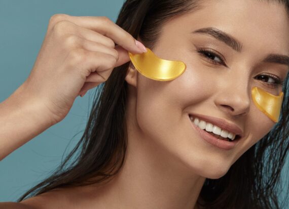 Woman removing gold under eye masks