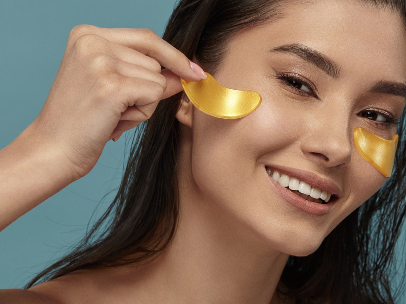 Woman removing gold under eye masks