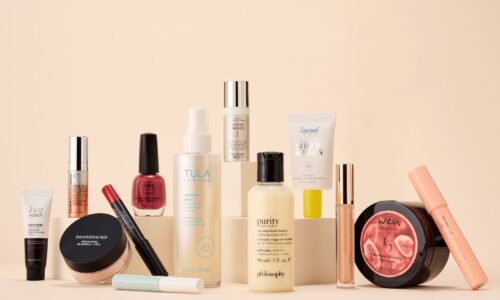Display of various beauty products on a neutral background