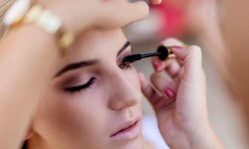 Make up artist applying mascara to a model