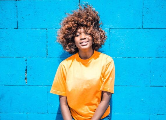 Spate What’s Trending In Hair Care On TikTok Woman with natural hair blowing in the wind