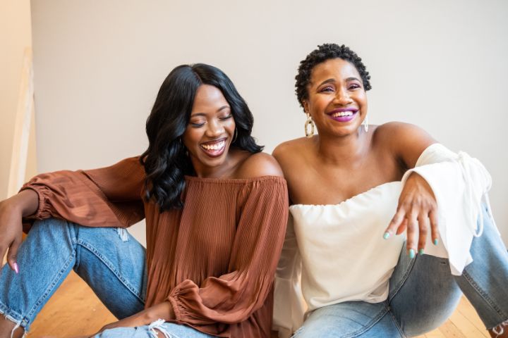 Two black women of varying ages laughing and smiling