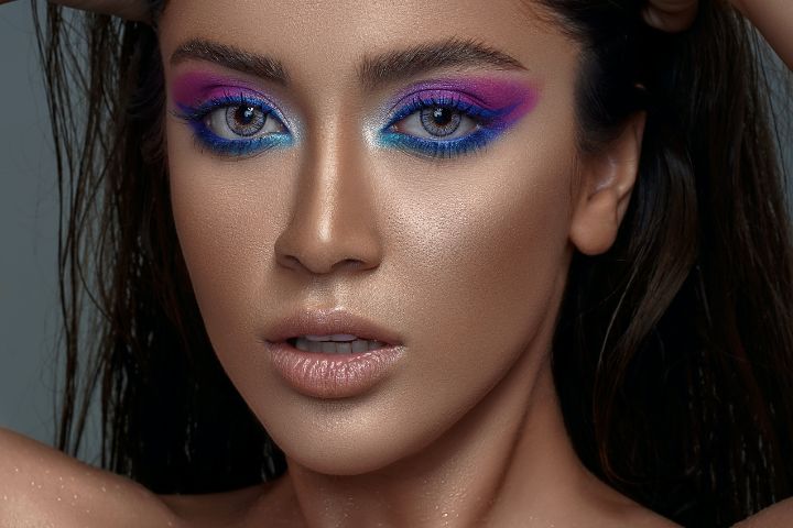 Woman with dramatic blue purple and pink eyeshadow