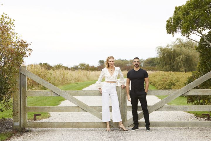 Emily Parr And Majeed Hemmat standing in front of a gate in the countryside