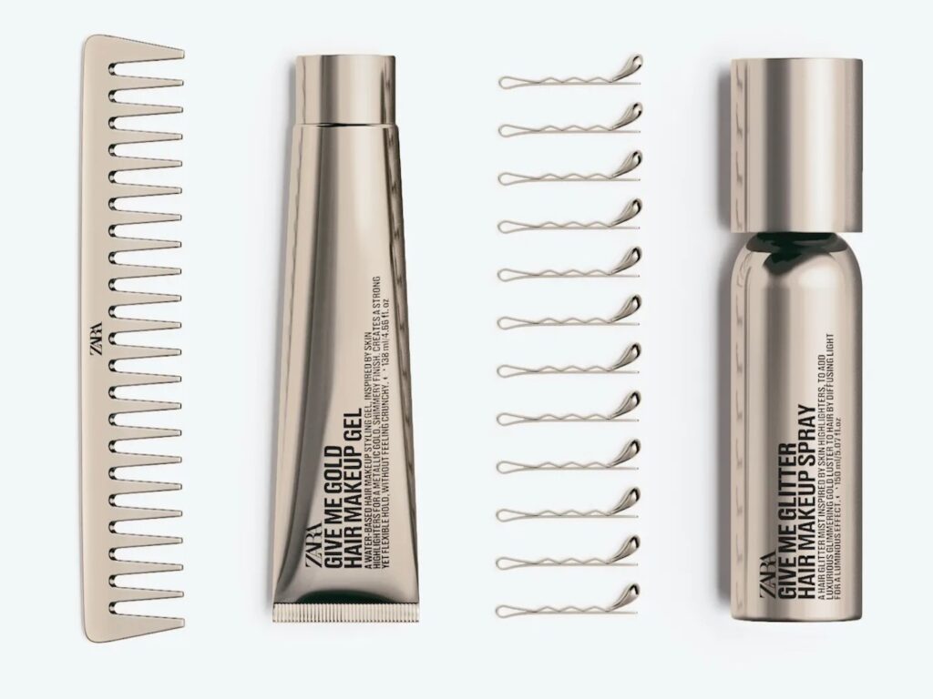 A gold hair comb, some golden hair grips, one gold tube and a gold can.
