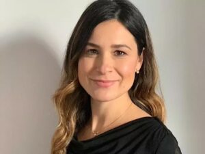 Woman smiling in a black sweater.