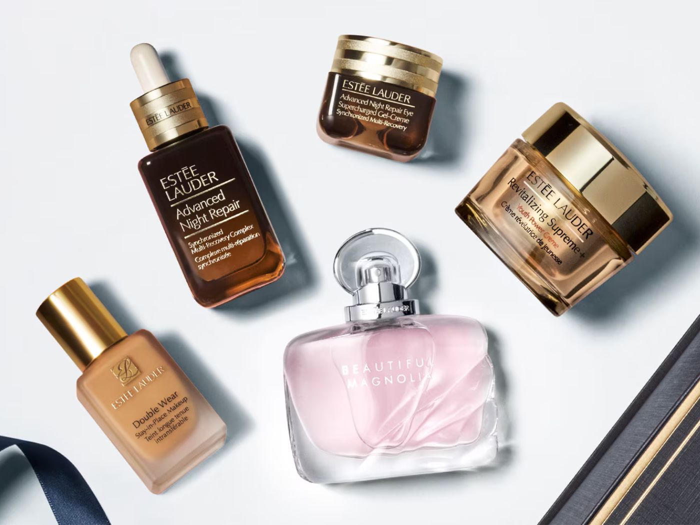 A selection of Estée Lauder skin care, makeup and fragrance products against a white backdrop