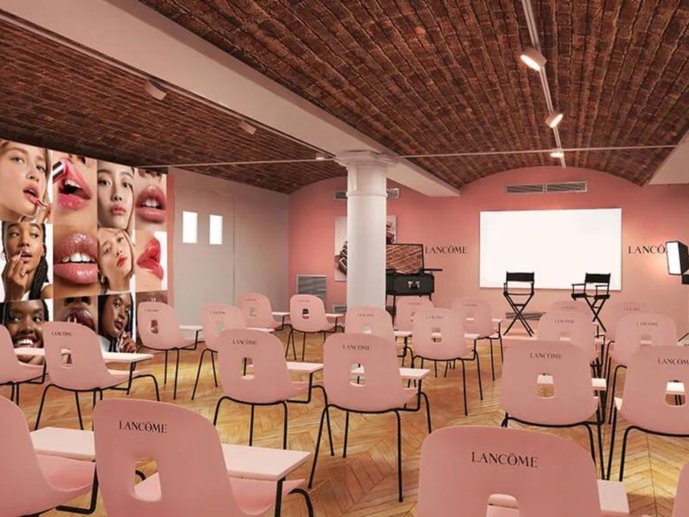 Pink themed classroom with chairs and a screen, and makeup photos on the walls.