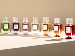 A line up of different coloured Valentino perfumes in glass, decanter-style bottles.