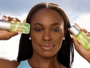 Sloane Stephens holds two Doc+Glo products in green bottles.