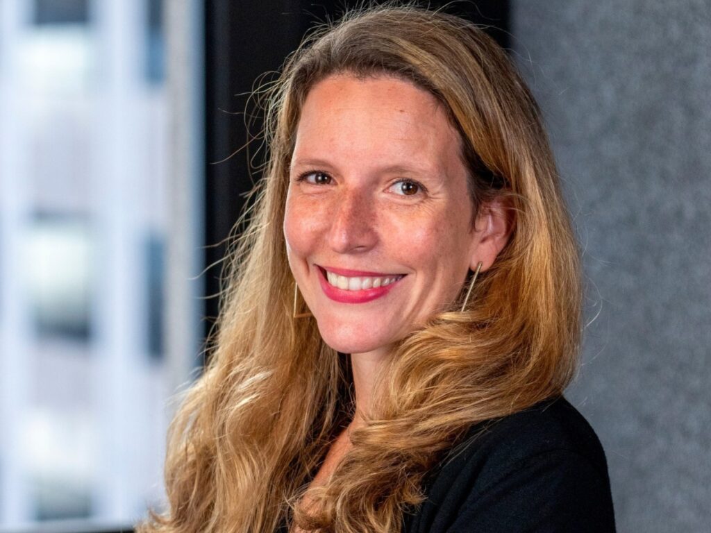 Delphine Herve portrait, smiling wearing a black top