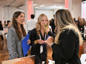 Photo of attendees trying out products at CEW's 2024 Beauty Expo