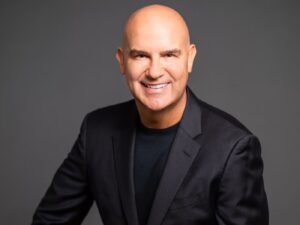 Portrait photo of Andrew Stanleick wearing a black blazer and black sweater