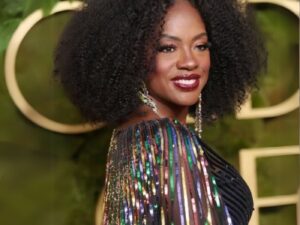 Viola Davies wears a shimmering multi-coloured dress and dark cherry lipstick at the Golden Globes