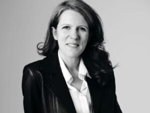 Black and white portrait photo of Catherine Spindler, wearing a white shirt and black blazer