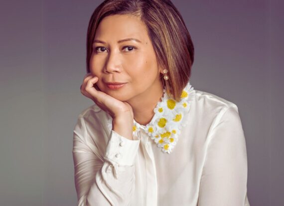 Liza Rapay, wearing a white blouse with daisy detail on the collar