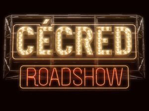 Neon sign lit up with words "CÉCRED ROADSHOW"