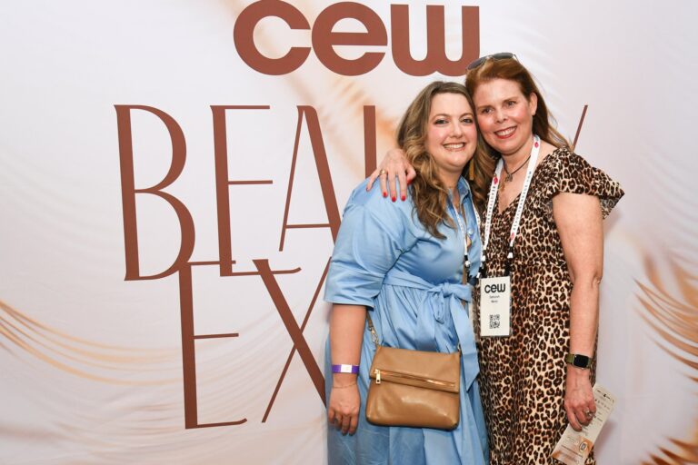 Deborah Mertz and a guest at the CEW Beauty Expo step and repeat
