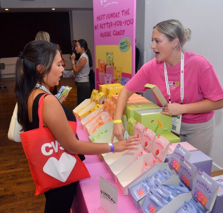 Guests at a brand booth on the Expo floor